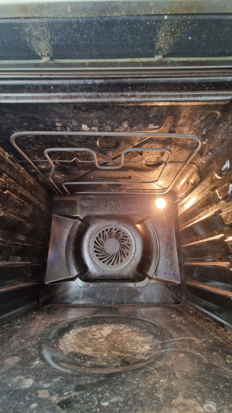 The same customer oven before cleaning, with burnt-on grease